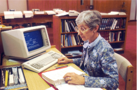 a librarian using a desktop IBM computer in 1987.